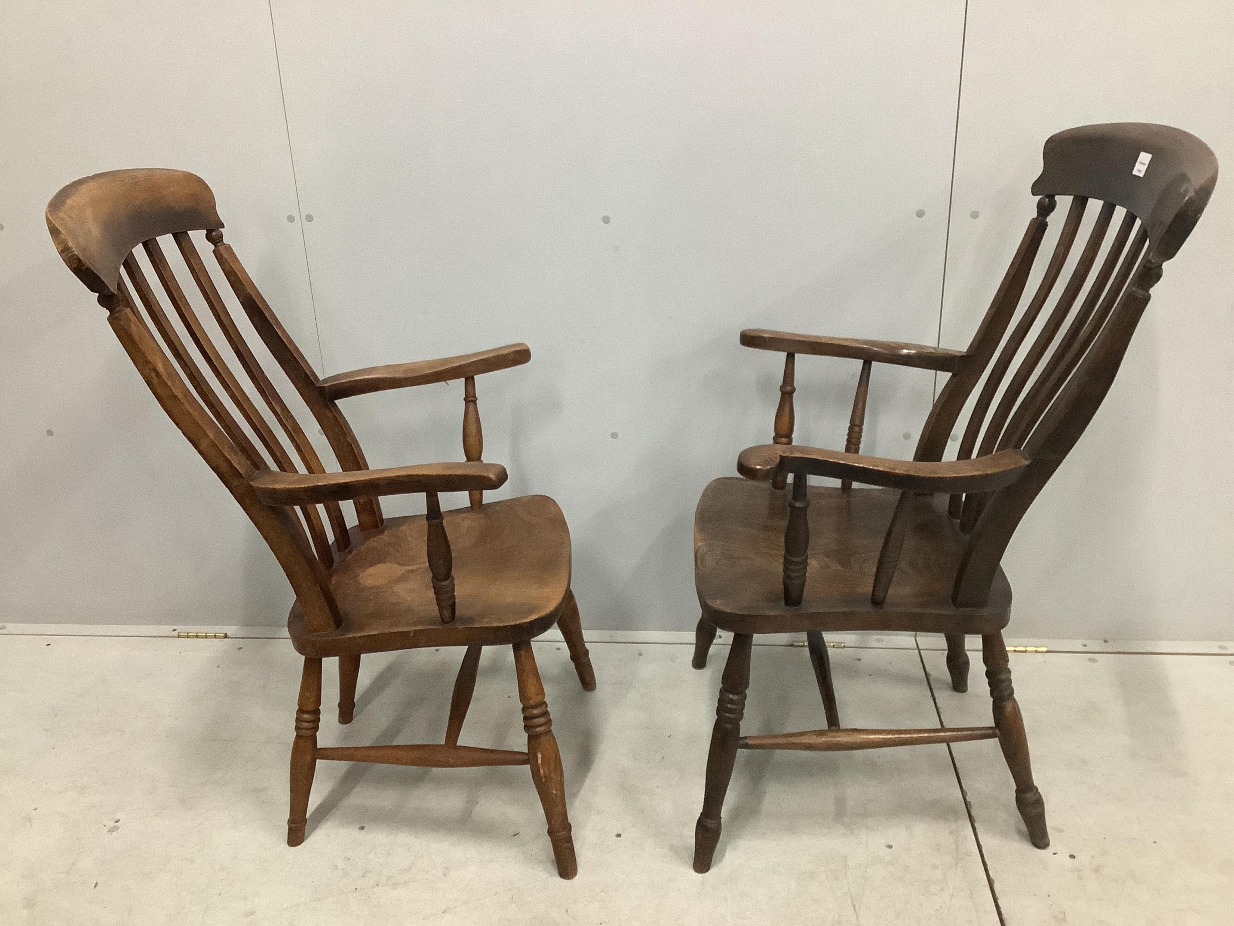 Two 19th century Windsor elm and beech lathe back armchairs, larger width 58cm, depth 48cm, height 110cm. Condition - fair